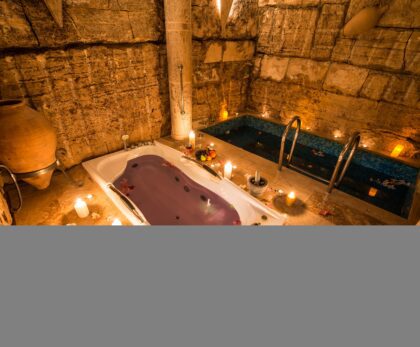 A beautiful shot of an ancient room design with a bathtub and a small indoor pool